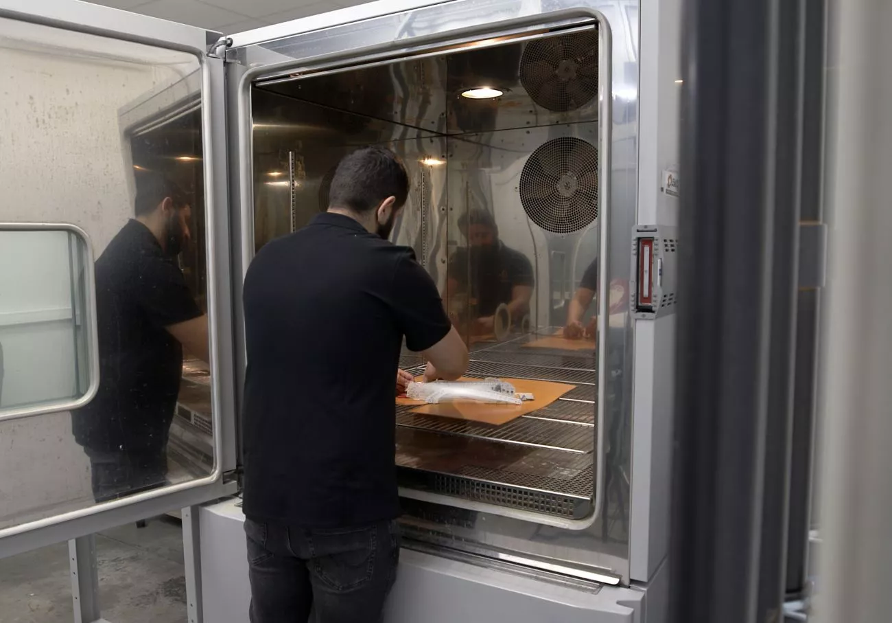 A test operator using a climatic chamber