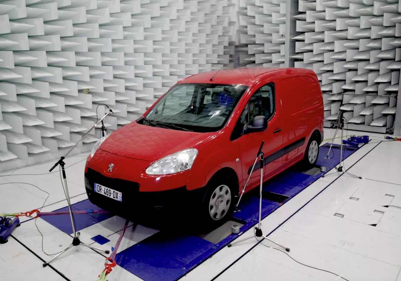 Acoustic testing of a vehicle on a chassis dynamometer in a semi-anechoic cage